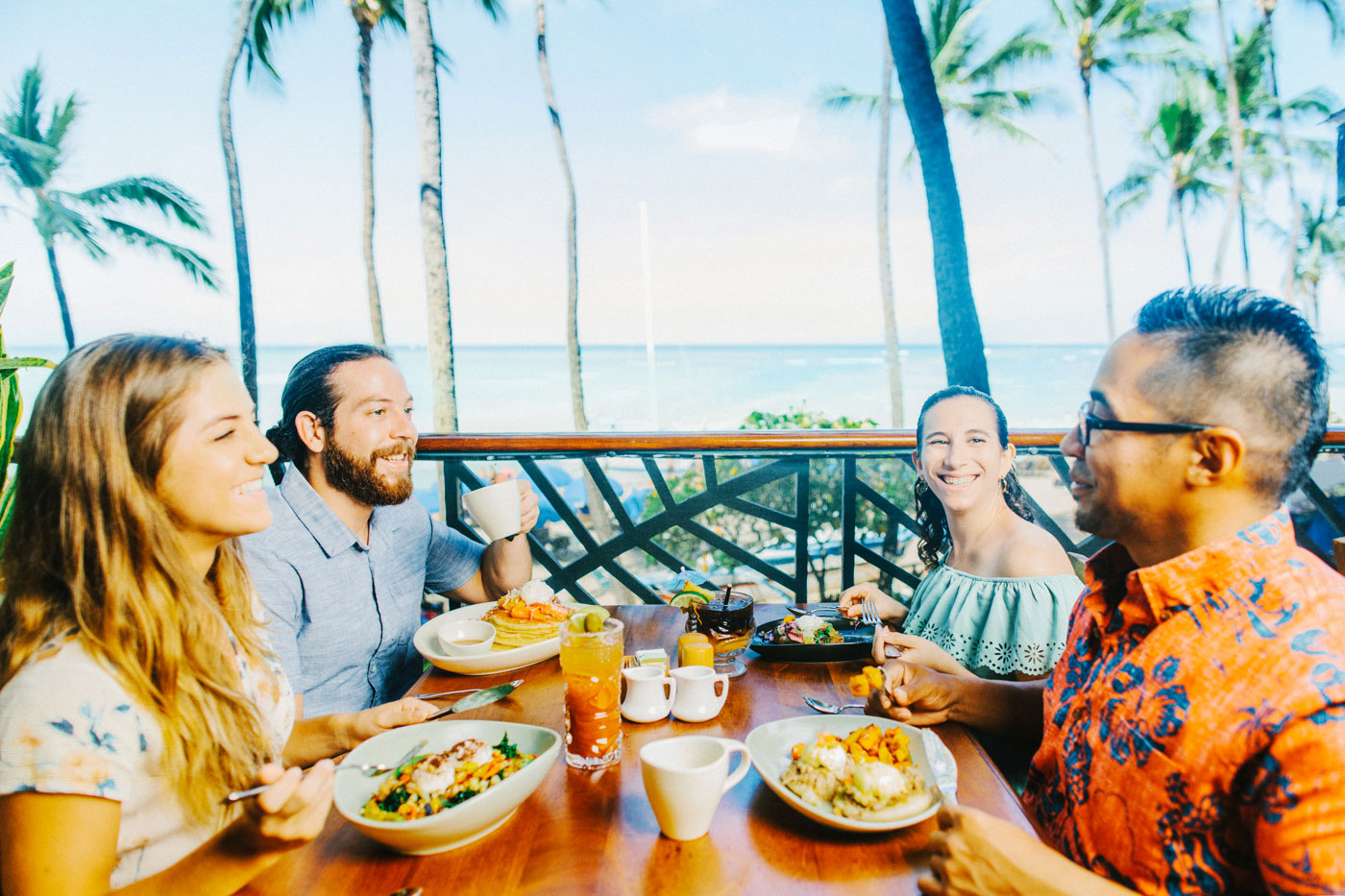 Group of friends enjoying their meal with ocean view