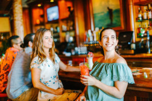 Two girls smiling at the bar
